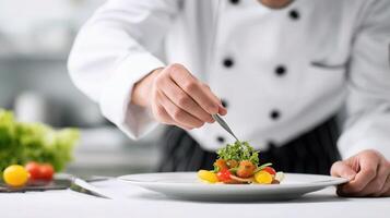 Chef preparing food on plate with knife photo