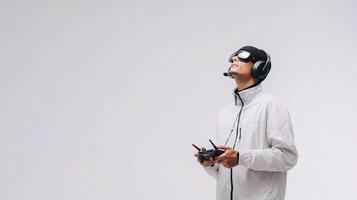 A man in a white jacket and goggles holding a remote control photo