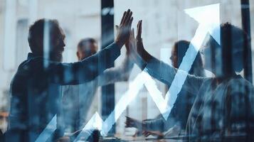 Business people raising hands in front of an upward graph photo