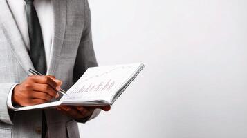 A man in a suit holding a notebook and pen photo