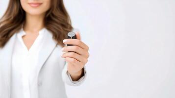 A woman in a business suit holding a remote control photo