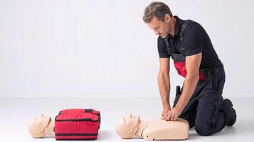 A man is kneeling down to put on an aed photo