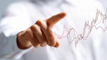 A person pointing at a chart with a finger photo