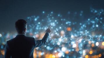 Businessman pointing at networked cityscape with networked dots photo