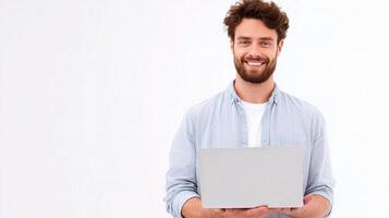 A man with a beard is holding a laptop photo