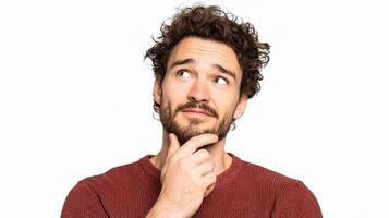 A man with curly hair and a beard is thinking photo