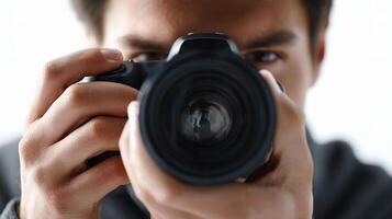 A man holding a camera in front of his face photo