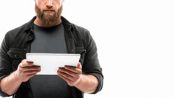 A bearded man holding a tablet computer photo