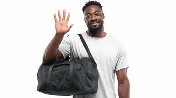 A man holding a duffel bag and waving photo