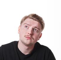 Lost in thoughts. Man with pensive thoughtful face looking away, thinking about something on white isolated studio background, portrait photo