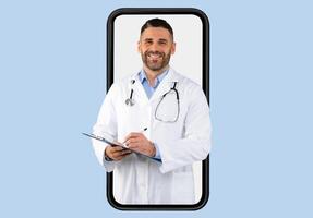 Telemedicine, appointment with doc online. Friendly middle aged doctor with clipboard and stethoscope at huge smartphone screen, isolated on blue background, collage photo