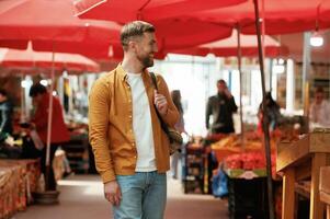 Front view, walking. Handsome man ,is on ,the street market or bazaar photo