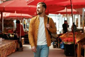 Front, view, walking. Handsome man is on the street market or bazaar photo