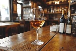 Elegant Wine Glass on Rustic Bar Table in Cozy Tavern Environment photo