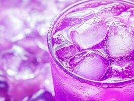 Refreshing purple drink with ice in a vibrant setting photo