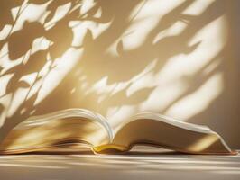 Open book on a table illuminated by soft shadow patterns photo