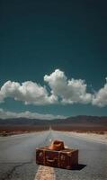 Vintage suitcase and fedora hat resting on a desert highway under a clear open sky photo