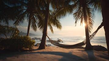 Tropical beach paradise with hammock swaying gently between palm trees at sunset photo