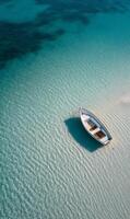 Serene boat resting on shallow turquoise waters in a tropical location on a sunny day photo