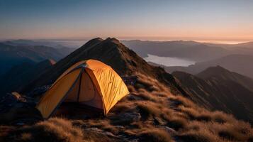 Camping on a high mountain peak, the scene is filled with golden light at sunrise photo