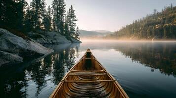 Wooden canoe floats on a tranquil lake surrounded by misty mountains and lush trees photo