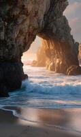 Golden hour bathes rugged cliffs and crashing waves in warm light at the coast photo