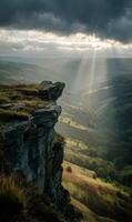Dramatic Peak District vista featuring sun rays shining through the clouds in England photo