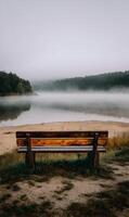 Silent lake scene with fog and wooden bench providing a peaceful and serene environment photo