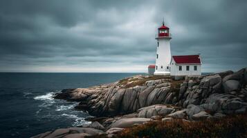 Peggy's Cove lighthouse stands guard against a backdrop of stormy seas and brooding skies photo