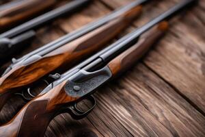 Hunting rifles with wooden stock resting on rustic table photo