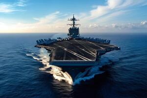 Nuclear powered aircraft carrier cruising in the ocean at sunset photo