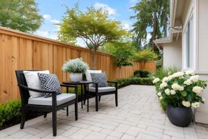 Relaxing backyard patio with comfortable seating and wooden fence photo