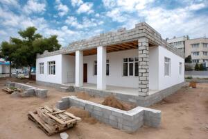 Unfinished house with concrete block columns under construction photo