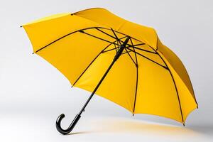 Bright yellow umbrella opened on white background providing protection from rain photo