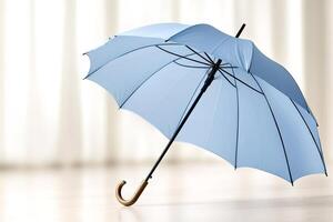 Light blue umbrella standing on wooden floor with bright background photo