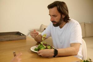 Man Enjoying a Healthy Salad Meal in a Cozy Home Setting photo