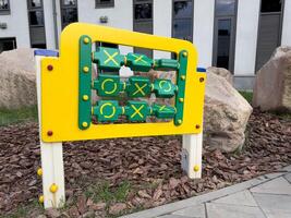 Outdoor game tic tac toe for teaching children during walk. Interactive panel for playing and developing child. Concept of improving logic from early age solving problems photo
