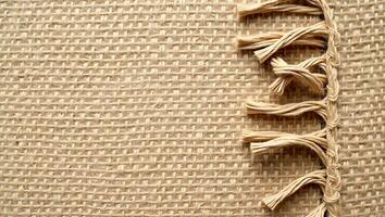 Close up view of burlap fabric with decorative stitching for rustic backgrounds and designs photo
