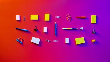 A collection of office supplies arranged neatly on a colorful gradient background photo