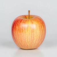 Red and Yellow Striped Apple on White Background photo