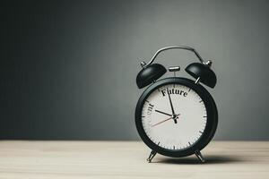 Hands of clock move from word Present to word Future, as the words fade away on black clock face. Concept of positive thinking, self-improvement motivation, business planning and Future trends. photo