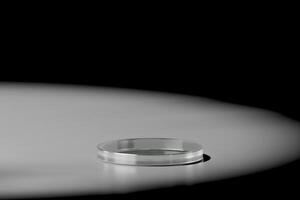 Clear glass podium with light dropping for product showing 3d rendering photo