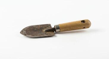 Old Rusty Garden Trowel with Wooden Handle on White Background photo