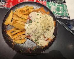 Traditional chop with cheese and French fries in an Argentine cafe photo
