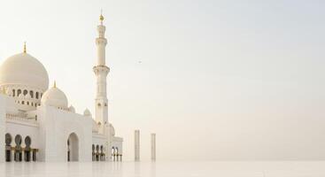 A Grand White Mosque Against a Hazy Sky in Abu Dhabi photo