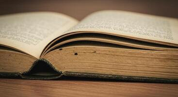 Exploring the Depths An Old Book Open on Wooden Surface photo