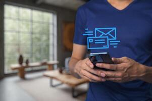 Man Using Smartphone to Receive and Manage Emails in Modern Setting photo
