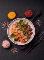 Bowl with tofu, quinoa, broccoli and carrots photo