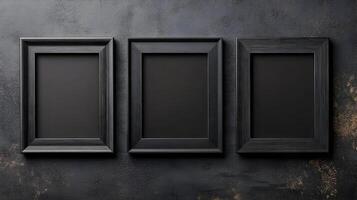 Three black empty picture frames hanging on a dark textured wall, presenting a minimalist and modern design concept. photo