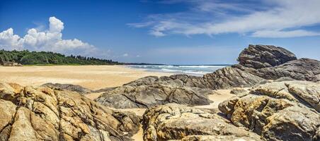 Sunny tropical beach with rocks and turquoise ocean in Sri Lanka 3 photo
